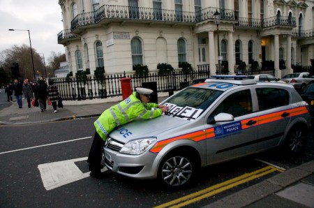 Policeman rearranging PEACE in CAPE! on his car